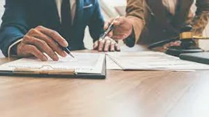 Close-up of attorney calculating damages in a settlement negotiation