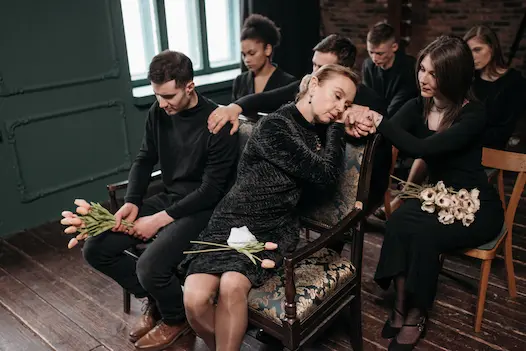 A grieving family seated together at a memorial service, representing a wrongful death claim in Illinois